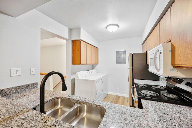 1508 Whispering Pines Way, Fitchburg, WI 53713 - kitchen featuring stainless steel electric stove, separate washer and dryer, white microwave, light wood-style floors, and electric panel