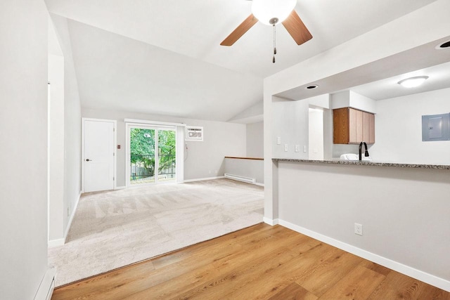 1508 Whispering Pines Way, Fitchburg, WI 53713 - unfurnished living room featuring a ceiling fan, light wood-style floors, lofted ceiling, electric panel, and baseboard heating
