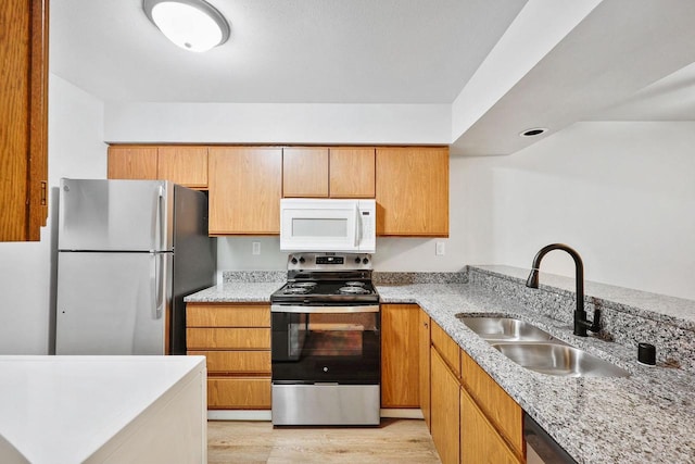 1508 Whispering Pines Way, Fitchburg, WI 53713 - kitchen with appliances with stainless steel finishes, light wood finished floors, and light stone counters