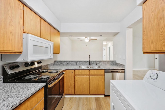 1508 Whispering Pines Way, Fitchburg, WI 53713 - kitchen with stainless steel appliances, washer / clothes dryer, ceiling fan, and light stone counters