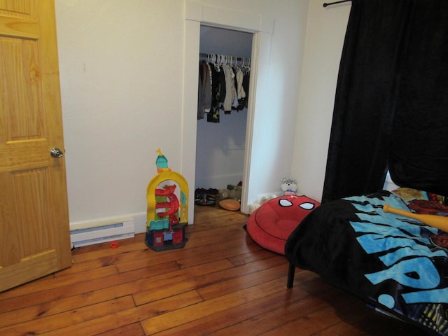 1326 N 11th St, Sheboygan, WI 53081 - bedroom with wood-type flooring and baseboard heating