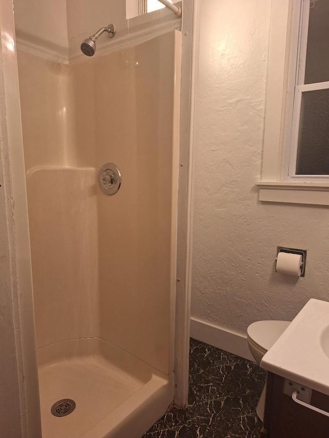 1326 N 11th St, Sheboygan, WI 53081 - bathroom with marble finish floors, a stall shower, vanity, and a textured wall