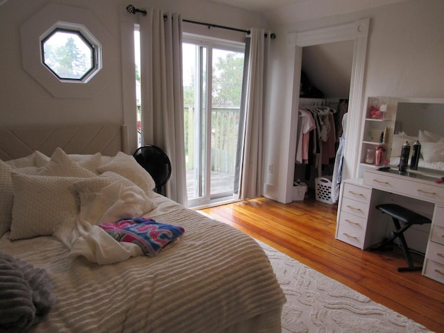 1326 N 11th St, Sheboygan, WI 53081 - bedroom featuring light wood-style floors, a closet, access to outside, and a walk in closet
