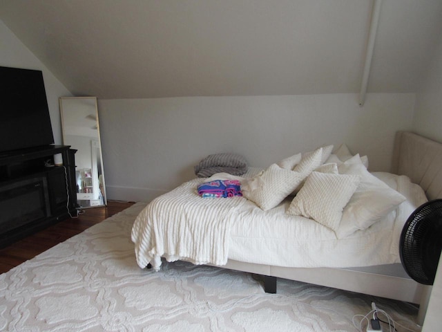 1326 N 11th St, Sheboygan, WI 53081 - bedroom with vaulted ceiling, wood finished floors, and a fireplace