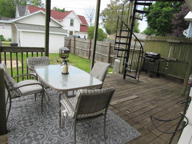 1326 N 11th St, Sheboygan, WI 53081 - wooden terrace featuring outdoor dining area, grilling area, and a fenced backyard