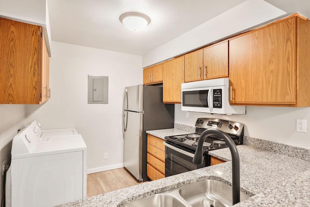 807 Whispering Pines Way, Fitchburg, WI 53713 - kitchen featuring white microwave, electric range, washer and dryer, electric panel, and light wood-style flooring
