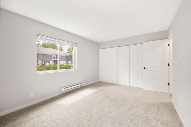 807 Whispering Pines Way, Fitchburg, WI 53713 - unfurnished bedroom featuring a baseboard radiator, carpet floors, and a closet