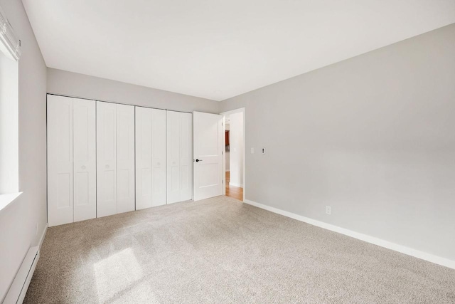 807 Whispering Pines Way, Fitchburg, WI 53713 - unfurnished bedroom featuring carpet, a baseboard heating unit, and a closet
