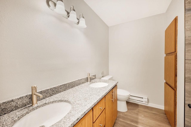 807 Whispering Pines Way, Fitchburg, WI 53713 - bathroom featuring baseboard heating, double vanity, and wood finished floors