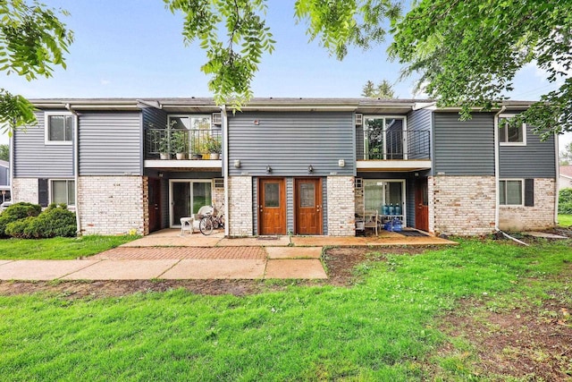 807 Whispering Pines Way, Fitchburg, WI 53713 - rear view of property with a balcony, brick siding, a yard, and a patio area