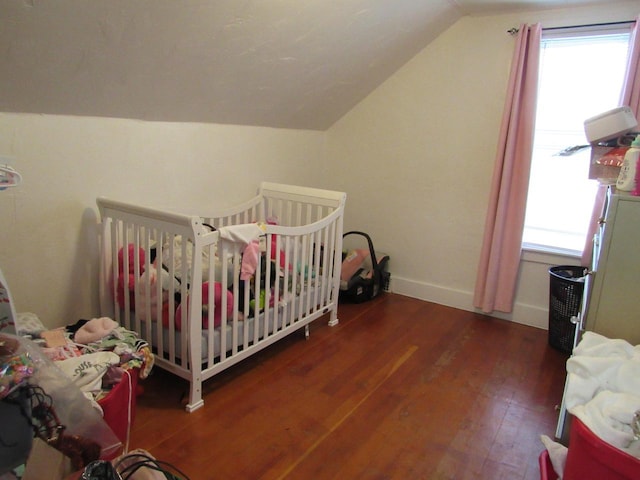 1744 N 27th St, Sheboygan, WI 53081 - bedroom with vaulted ceiling, multiple windows, and wood finished floors