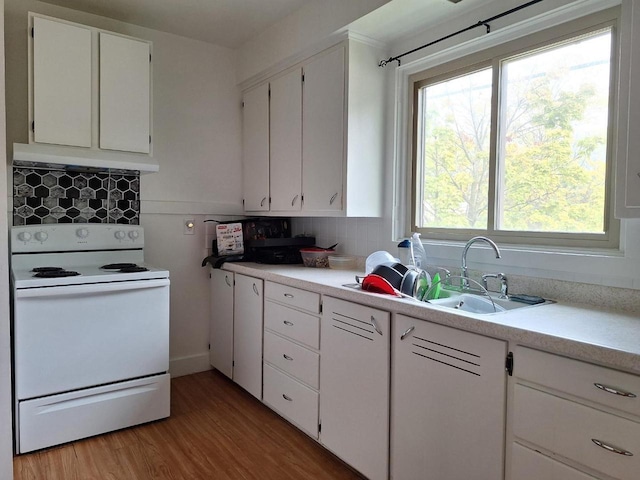 1744 N 27th St, Sheboygan, WI 53081 - kitchen featuring white electric range, under cabinet range hood, light wood-type flooring, and light countertops