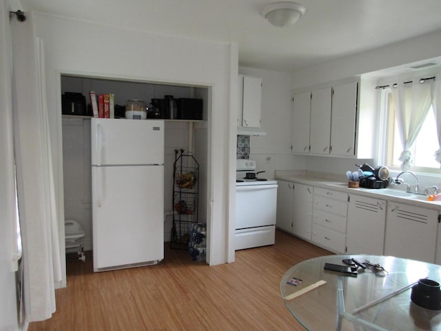 1744 N 27th St, Sheboygan, WI 53081 - kitchen featuring white appliances, light wood-type flooring, light countertops, white cabinetry, and under cabinet range hood