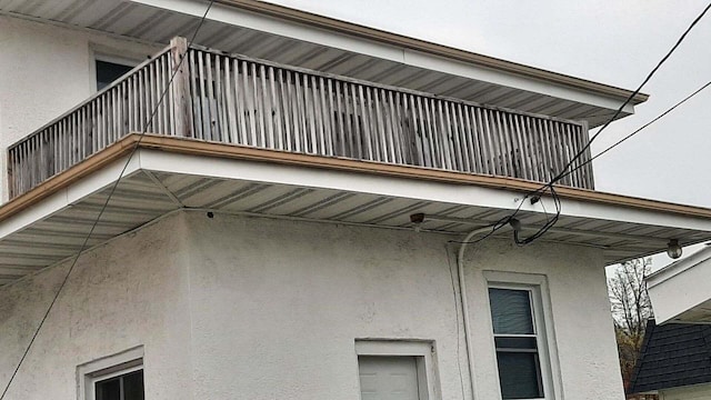 616 N 14th St, Sheboygan, WI 53081 - view of side of home with stucco siding and a balcony