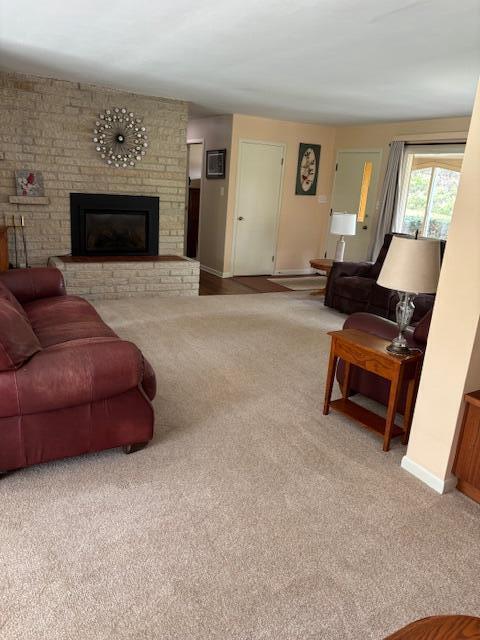 3415 N 105th St, Wauwatosa, WI 53222 - living room featuring carpet and a fireplace