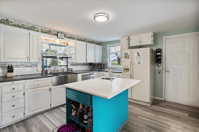 11165 Main St, Hewitt, WI 54441 - kitchen with stainless steel appliances, white cabinets, backsplash, and light wood-style floors