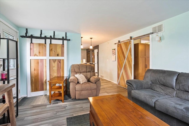 11165 Main St, Hewitt, WI 54441 - living room with a barn door and light wood-type flooring