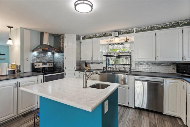 11165 Main St, Hewitt, WI 54441 - kitchen with wall chimney range hood, stainless steel appliances, tasteful backsplash, and white cabinetry