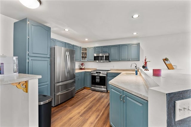 3713 Kingswood Ct, Eau Claire, WI 54701 - kitchen featuring stainless steel appliances, a peninsula, light countertops, recessed lighting, and dark wood-style floors