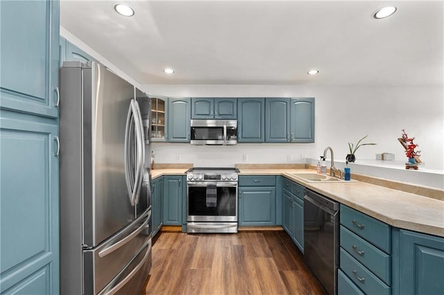 3713 Kingswood Ct, Eau Claire, WI 54701 - kitchen with appliances with stainless steel finishes, recessed lighting, dark wood-style flooring, blue cabinets, and light countertops