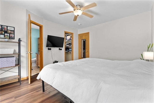 3713 Kingswood Ct, Eau Claire, WI 54701 - bedroom with wood finished floors, a ceiling fan, a walk in closet, and a closet