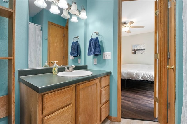 3713 Kingswood Ct, Eau Claire, WI 54701 - ensuite bathroom featuring vanity, wood finished floors, and ceiling fan