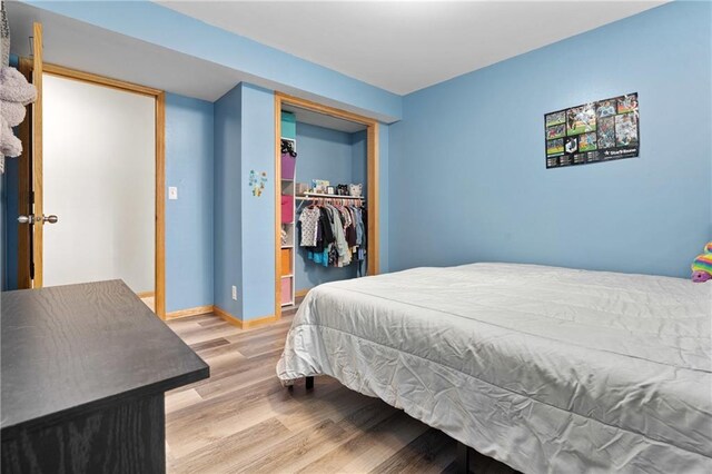 3713 Kingswood Ct, Eau Claire, WI 54701 - bedroom featuring wood finished floors, a closet, and a walk in closet
