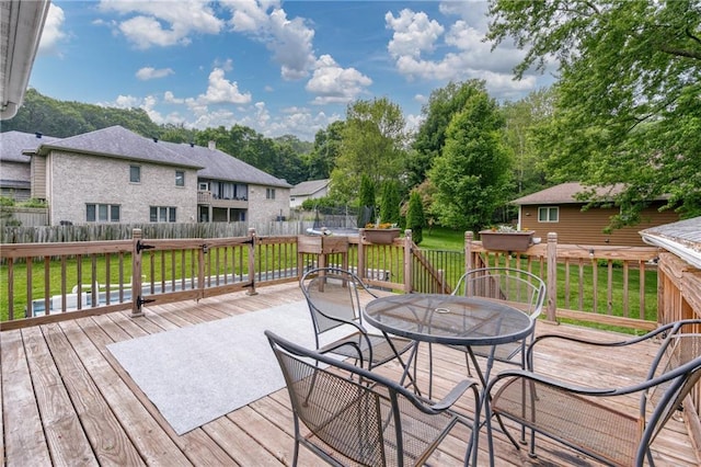 3713 Kingswood Ct, Eau Claire, WI 54701 - wooden terrace featuring outdoor dining space, a fenced backyard, and a residential view