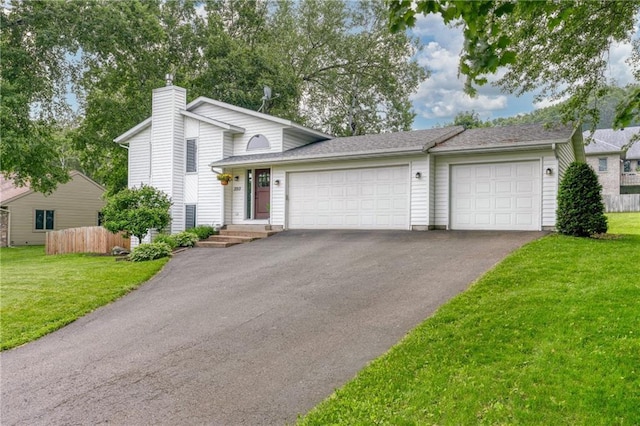 3713 Kingswood Ct, Eau Claire, WI 54701 - tri-level home with asphalt driveway, an attached garage, and a chimney