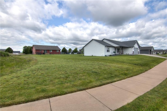 1040 Wissota Green Pkwy, Chippewa Falls, WI 54729 - view of side of home featuring driveway, a garage, and a lawn