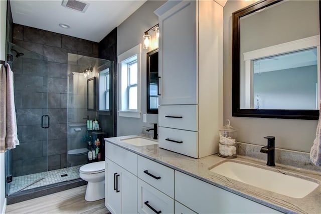1040 Wissota Green Pkwy, Chippewa Falls, WI 54729 - full bath featuring double vanity, a stall shower, wood finished floors, and recessed lighting