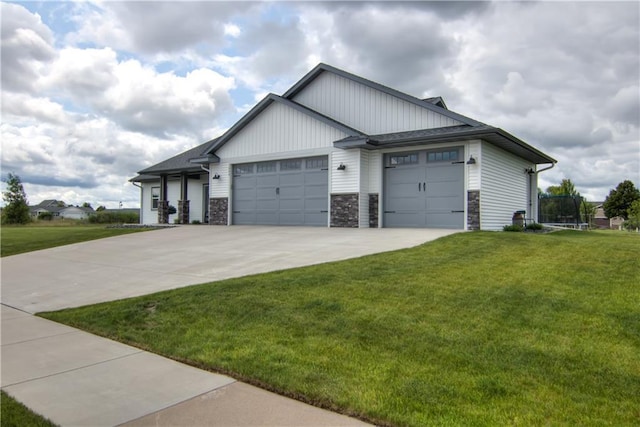 1040 Wissota Green Pkwy, Chippewa Falls, WI 54729 - view of front facade with a front yard, a garage, driveway, and a trampoline