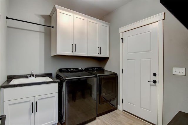 1040 Wissota Green Pkwy, Chippewa Falls, WI 54729 - laundry area with cabinet space, washer and clothes dryer, and light wood-style flooring