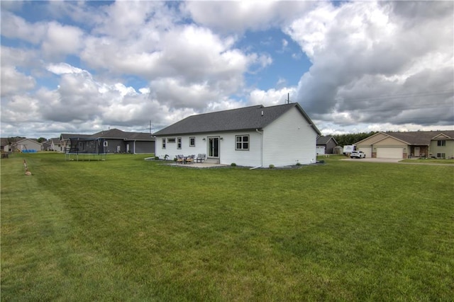 1040 Wissota Green Pkwy, Chippewa Falls, WI 54729 - back of house with a trampoline, a patio, and a yard