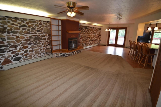 3917 Ross Ave, Weston, WI 54401 - living room featuring a baseboard heating unit, ceiling fan, a glass covered fireplace, baseboard heating, and carpet flooring