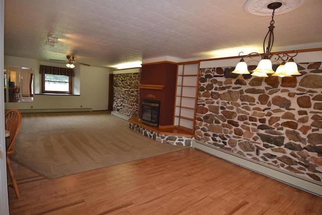 3917 Ross Ave, Weston, WI 54401 - unfurnished living room featuring baseboard heating, wood finished floors, a chandelier, and a glass covered fireplace