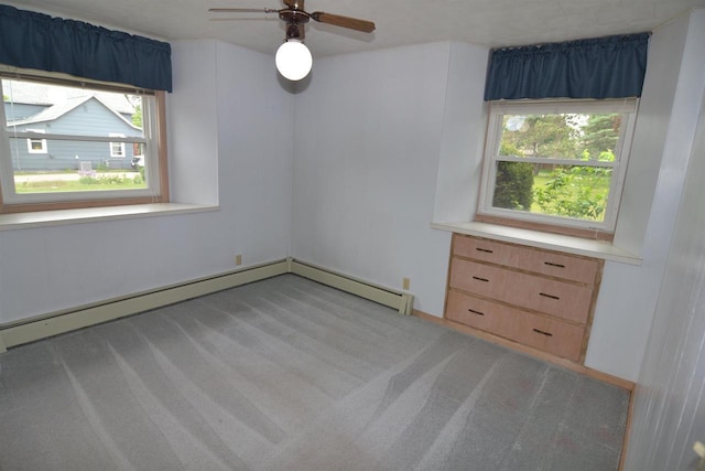 3917 Ross Ave, Weston, WI 54401 - unfurnished room featuring light colored carpet, plenty of natural light, a baseboard radiator, and a ceiling fan