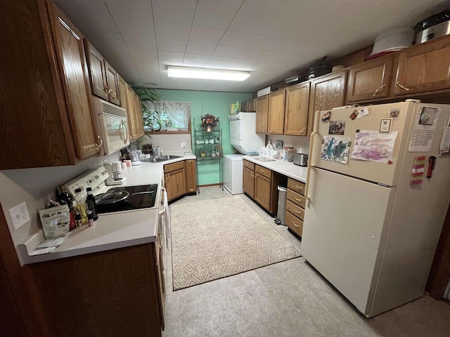 3917 Ross Ave, Weston, WI 54401 - kitchen with white appliances, washer / dryer, light countertops, and brown cabinetry