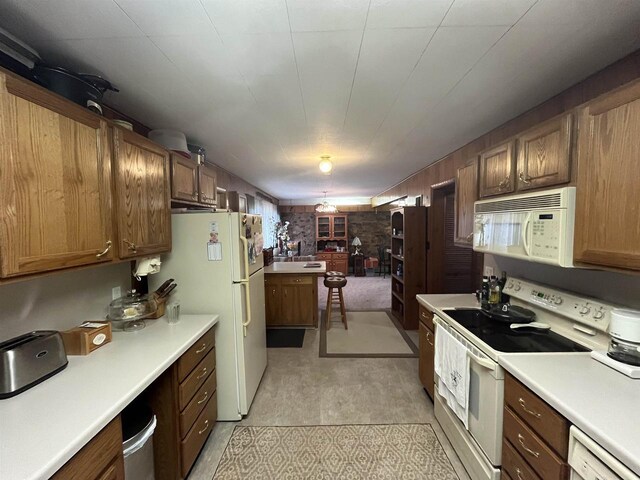 3917 Ross Ave, Weston, WI 54401 - kitchen featuring white appliances, light countertops, and brown cabinetry