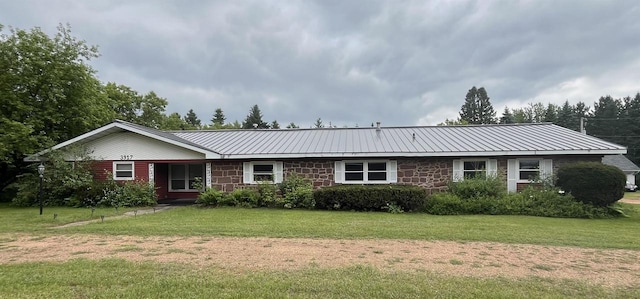 3917 Ross Ave, Weston, WI 54401 - ranch-style house with stone siding, a front yard, and a metal roof