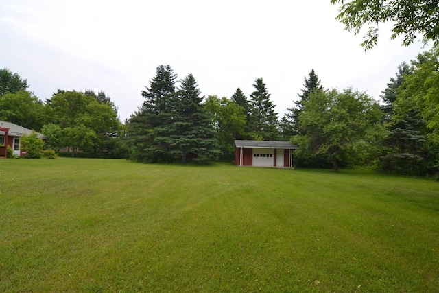 3917 Ross Ave, Weston, WI 54401 - view of green lawn with a storage shed and a garage