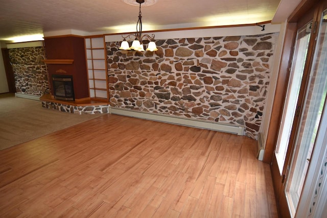 3917 Ross Ave, Weston, WI 54401 - spare room featuring a baseboard heating unit, wood finished floors, and a glass covered fireplace
