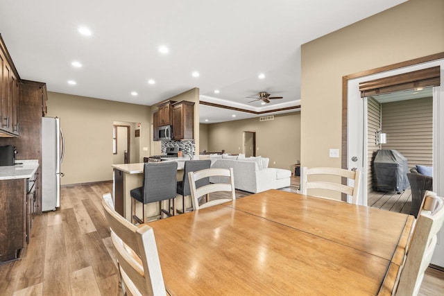 3830 Augusta Ct, Plover, WI 54467 - dining room with ceiling fan, light wood finished floors, and recessed lighting