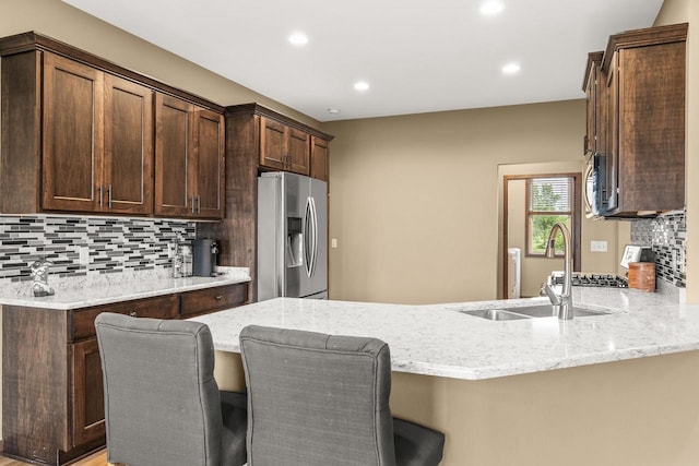 3830 Augusta Ct, Plover, WI 54467 - kitchen featuring appliances with stainless steel finishes, light stone counters, decorative backsplash, and recessed lighting