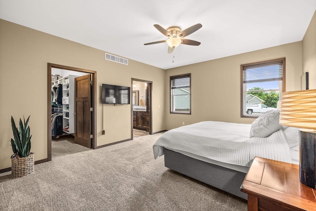 3830 Augusta Ct, Plover, WI 54467 - bedroom featuring light colored carpet, a walk in closet, ensuite bathroom, a closet, and ceiling fan