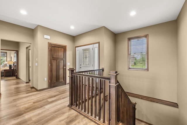 3830 Augusta Ct, Plover, WI 54467 - hall with an upstairs landing, light wood finished floors, and recessed lighting