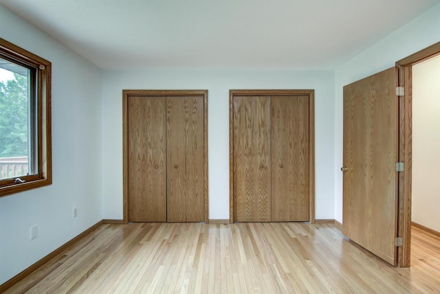 8103 W Folsom St, Eau Claire, WI 54703 - unfurnished bedroom with light wood finished floors and multiple closets