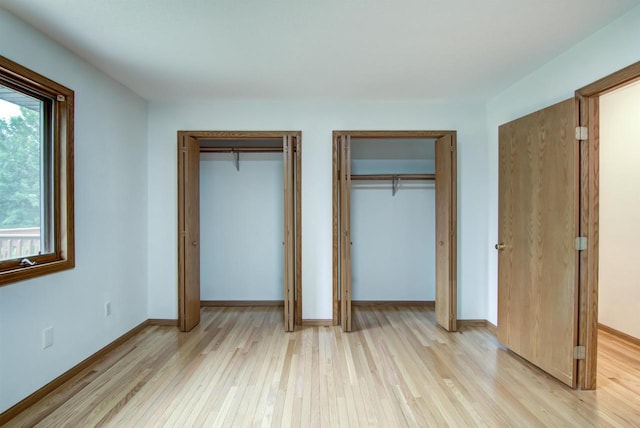 8103 W Folsom St, Eau Claire, WI 54703 - unfurnished bedroom with two closets and light wood finished floors