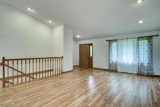 8103 W Folsom St, Eau Claire, WI 54703 - empty room featuring vaulted ceiling, wood finished floors, and recessed lighting