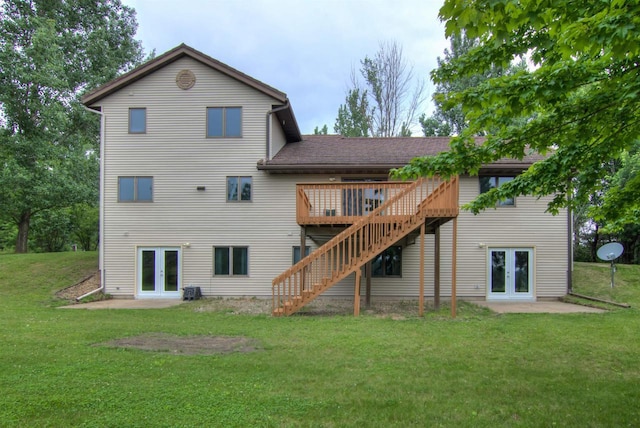 8103 W Folsom St, Eau Claire, WI 54703 - back of house featuring french doors, a lawn, a deck, stairway, and a patio area
